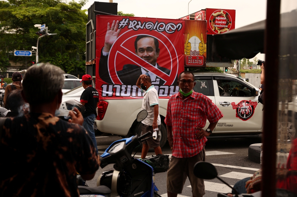 Protesters gather next to a picture of Thailand's Prime Minister Prayuth Chan-ocha outside the Government House, in Bangkok, on August 24, 2022. REUTERS/Athit Perawongmetha