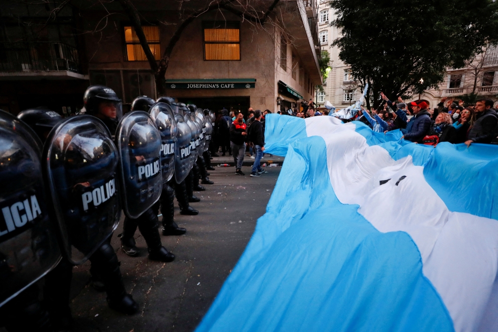 Supporters gather outside the house of Argentina's Vice President Cristina Fernandez de Kirchner as police officers hold their shields in Buenos Aires, Argentina, August 27, 2022. Reuters/Agustin Marcarian