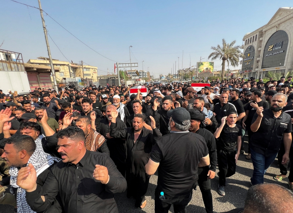 Mourners carry the coffins of fighters from Sadr's Peace Brigades, who were killed during clashes among rival Shiite Muslim militants in Basra, Iraq, on September 1, 2022. REUTERS/Mohammed Aty
