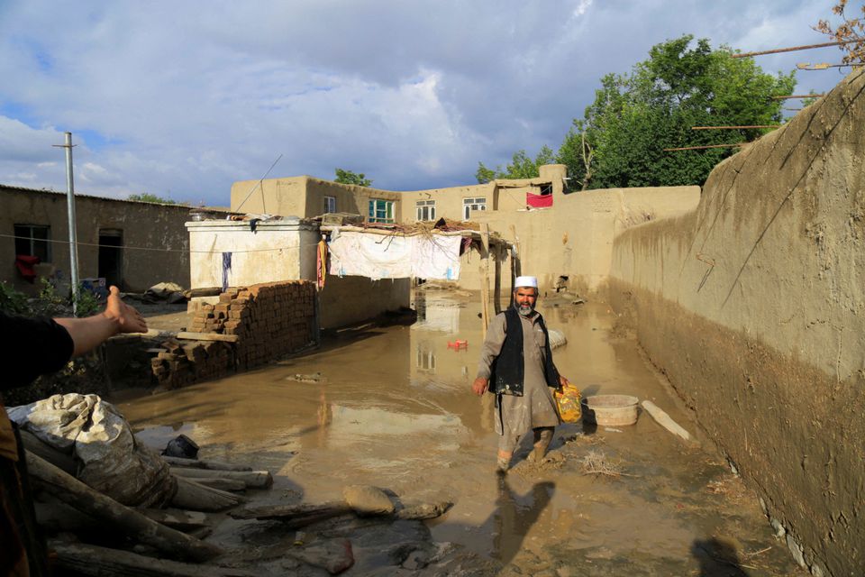 An Afghan man cleans up his damaged home after the heavy flood in the Khushi district of Logar, Afghanistan, August 21, 2022. REUTERS/Stringer

