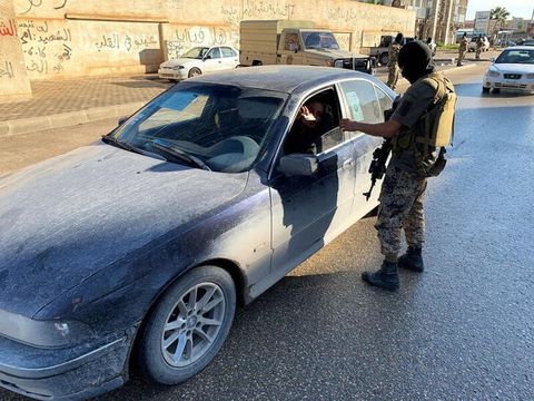 A member of the Libyan security forces checks a driver's document as they are deployed in Misrata, Libya November 19, 2020. REUTERS/Ayman Al-Sahili/