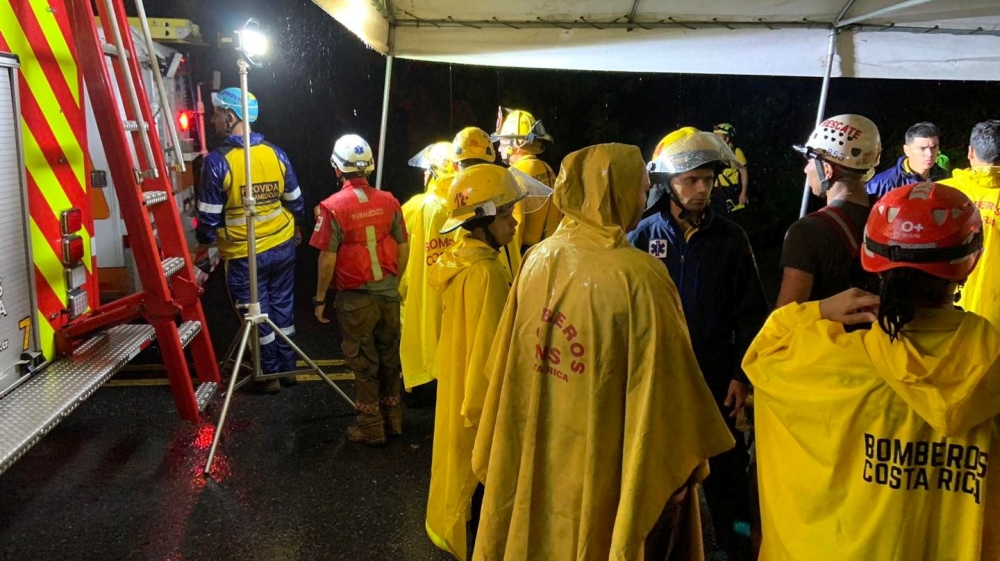 Firefighters work at the scene of a deadly bus accident, where a landslide reportedly hit the vehicle, throwing it off a cliff, in Cambronero, Alajuela Province, Costa Rica in this social media handout image released September 17, 2022. Benemerito Cuerpo De Bomberos De Costa Rica/Handout via REUTERS