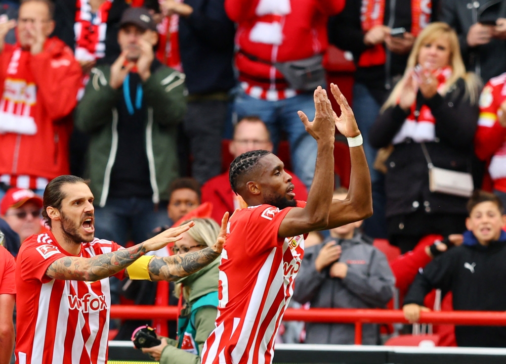 FC Union Berlin's Jordan Pefok (right) celebrates scoring their first goal with Christopher Trimmel during their German Bundesliga match against VfL Wolfsburg at the Stadion An der Alten Forsterei, Berlin, on September 18, 2022 1.  REUTERS/Fabrizio Bensch