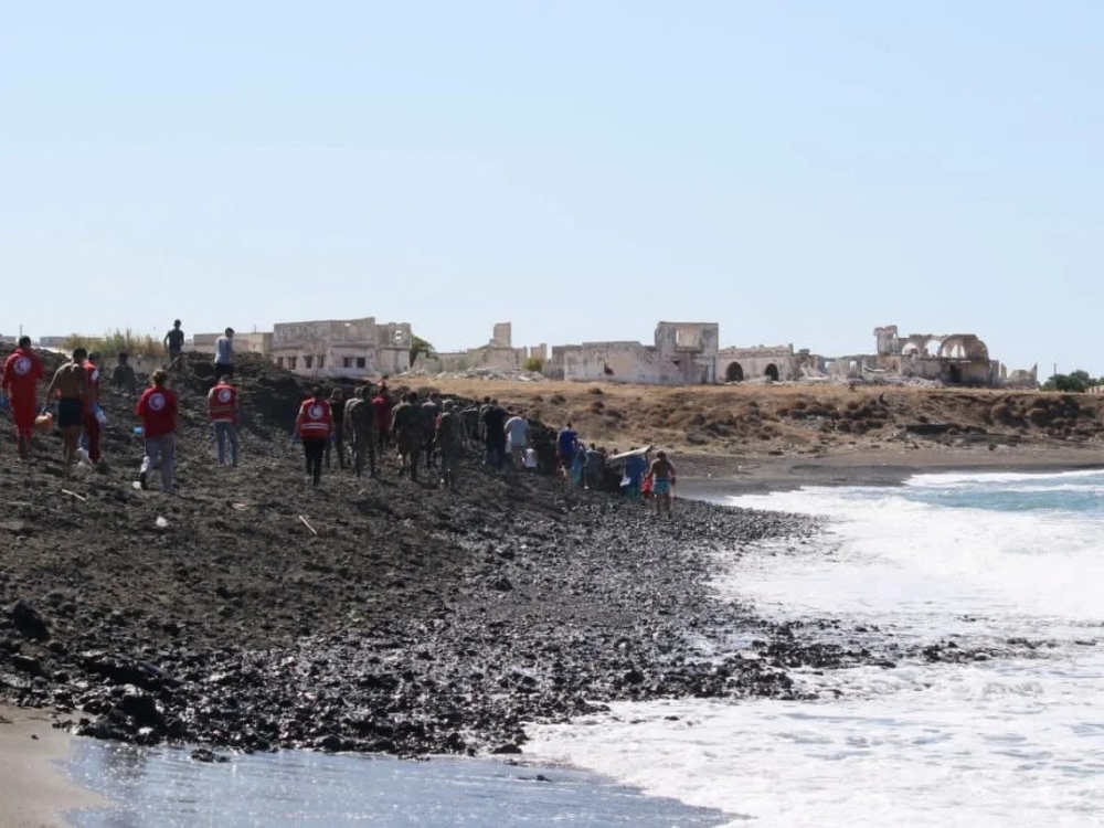 Members of Syrian Red Crescent work by a shoreline following a migrant boat, which according to Lebanese and Syrian officials, sank off the Syrian coast after sailing from Lebanon, in Tartous, Syria September 24, 2022. Courtesy of Syrian Red Crescent