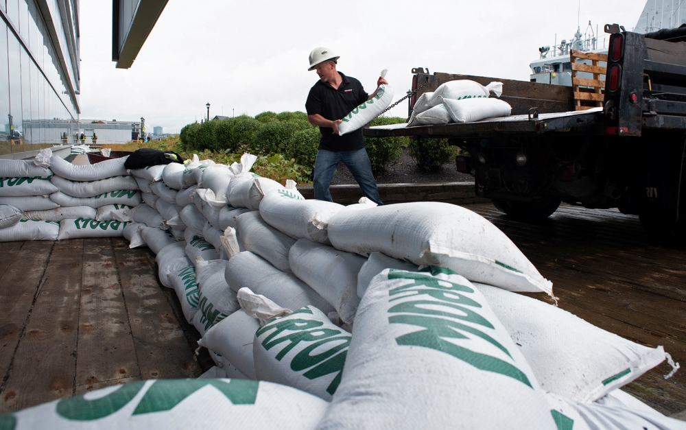Francis Bruhm, Project Manager for general contractor G&R Kelly, places sandbags around the doors of the Nova Scotia Power building in Halifax, Nova Scotia, Canada September 23, 2022. Reuters/Ingrid Bulmer