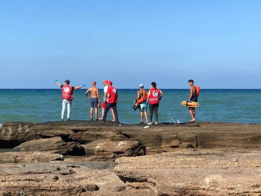 Members of Syrian Red Crescent stand by a shoreline following a migrant boat, which according to Lebanese and Syrian officials, sank off the Syrian coast after sailing from Lebanon, in Tartous, Syria on September 24, 2022. Courtesy of Syrian Red Crescent/Handout via REUTERS
