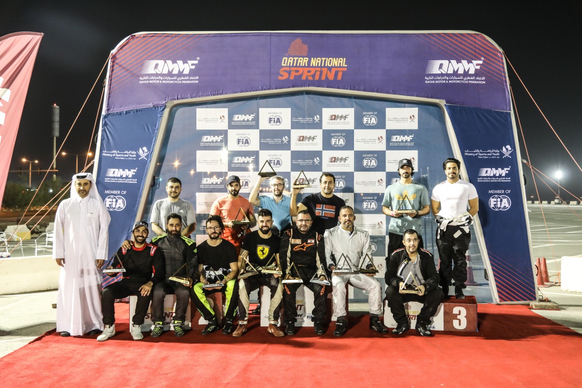 Qatar Motor and Motorcycle Federation's Secretary General Abdul Razzaq Al Kuwari with the podium winners at the end of the third round on Friday.