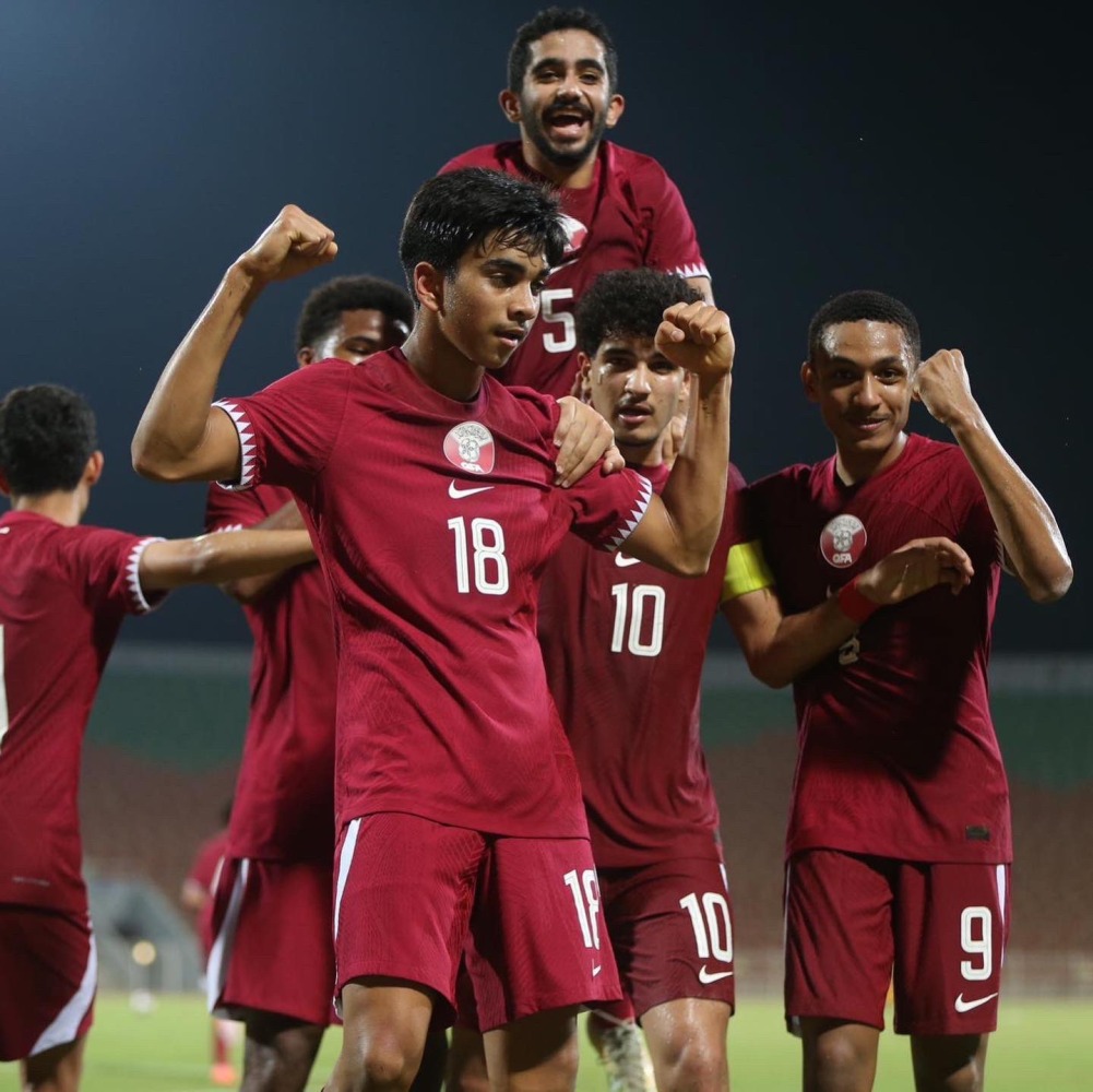 Qatar players celebrate.