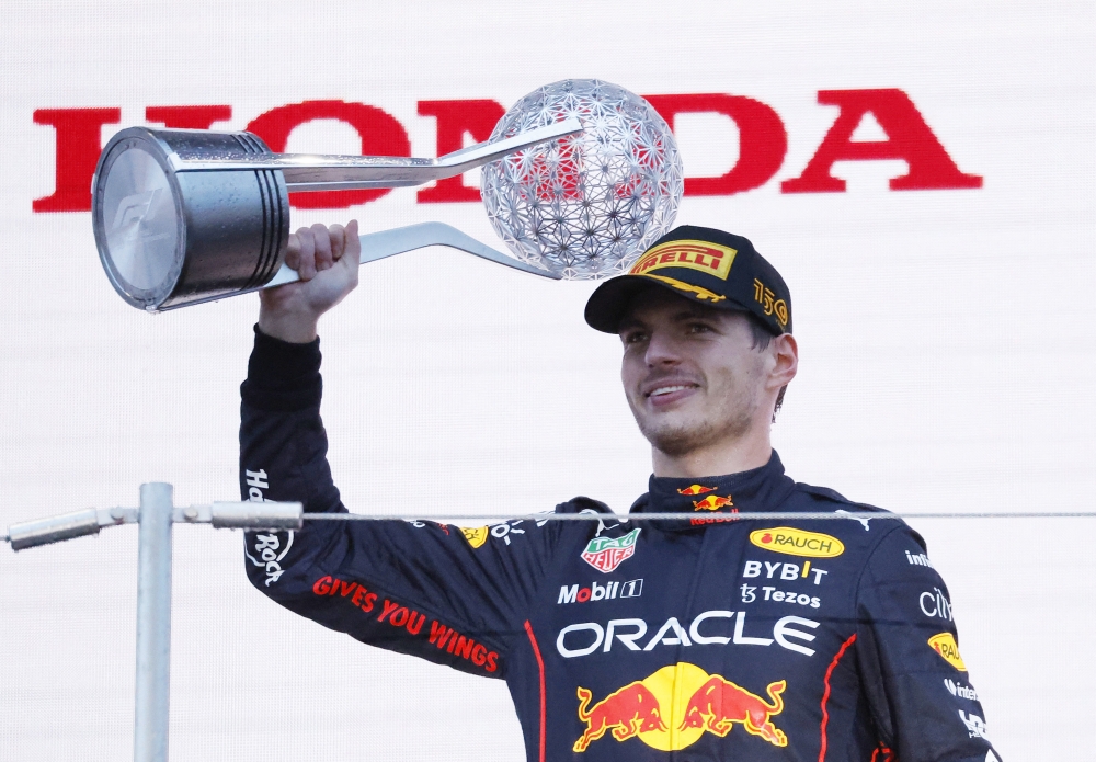 Red Bull's Max Verstappen celebrates winning the race and the championship on the podium Reuters/Issei Kato
