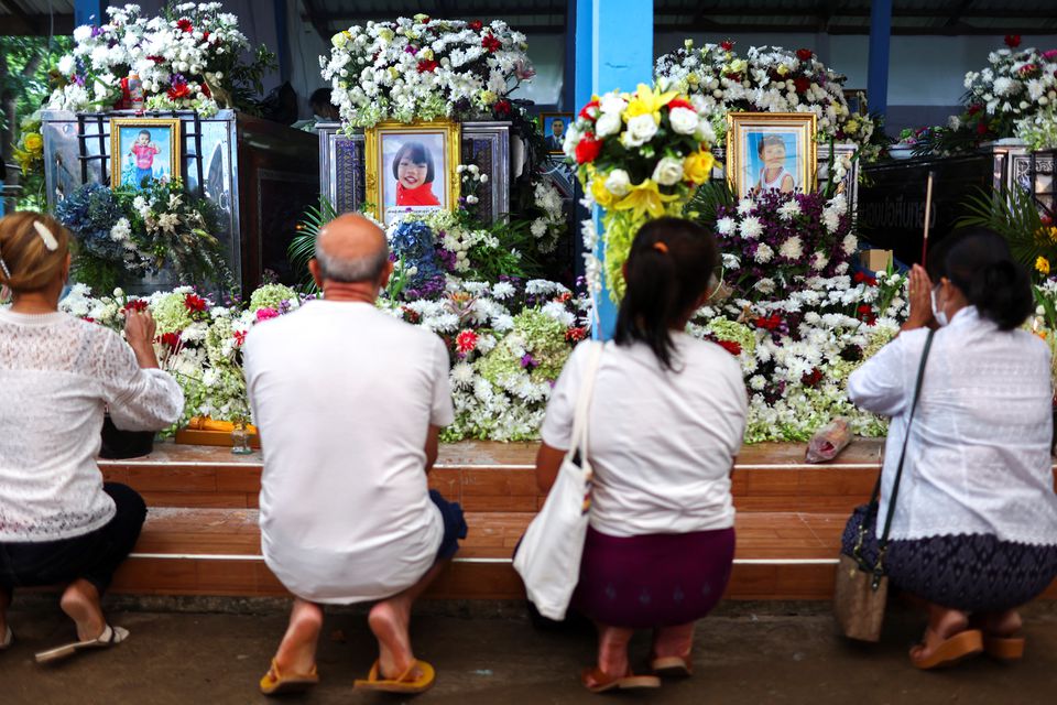 People pray at Wat Si Uthai temple following a mass shooting in the town of Uthai Sawan, Nong Bua Lam Phu province, Thailand October 10, 2022. REUTERS/Athit Perawongmetha
