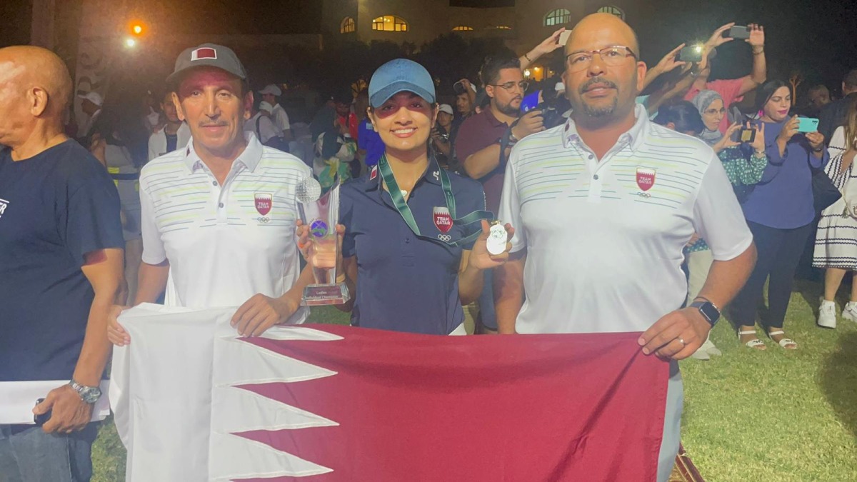 Qatar’s Nada Radwan poses with her gold medal and trophy. 