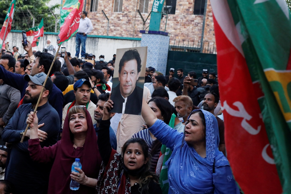Supporters of the Pakistan Tehreek-e-Insaf (PTI) political party chant slogans as they gather, after Pakistan Election Commission disqualifies former Prime Minister Imran Khan on charges of unlawfully selling state gifts, during a protest in Karachi, Pakistan, October 21, 2022. (REUTERS/Akhtar Soomro)