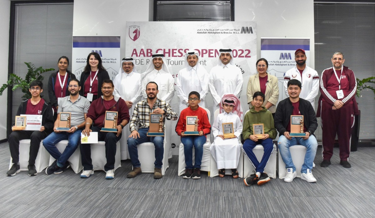 The trophy winning players pose for a picture with officials after the conclusion of AAB Chess Open.  