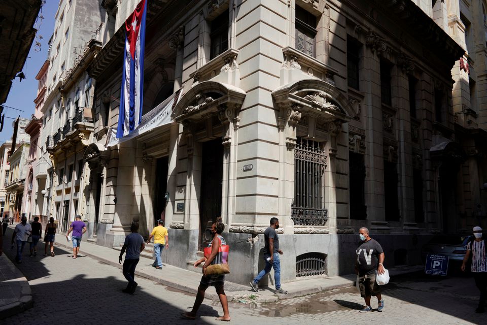 People walk under a Cuban flag at a commercial area in Havana, Cuba, on August 3, 2021. File Photo / Reuters