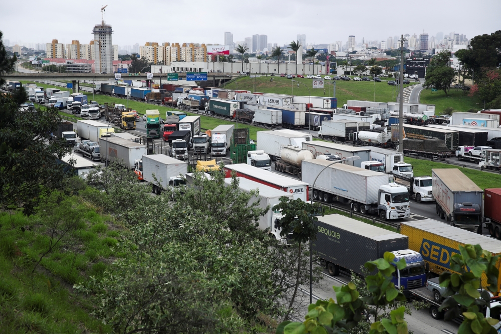 Supporters of Brazil's President Jair Bolsonaro, mainly truck drivers, block the Castello Branco highway during a protest over Bolsonaro's defeat in the presidential run-off election, in Barueri, Brazil, on November 1, 2022. REUTERS/Carla Carniel