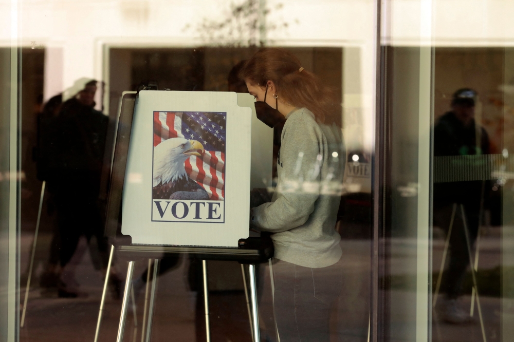 People cast their early ballots for the 2022 general election at the Ann Arbor, Michigan city clerk's satellite office on the campus of the University of Michigan, on the eve of the US midterm elections, on November 7, 2022. (Photo by JEFF KOWALSKY / AFP)
