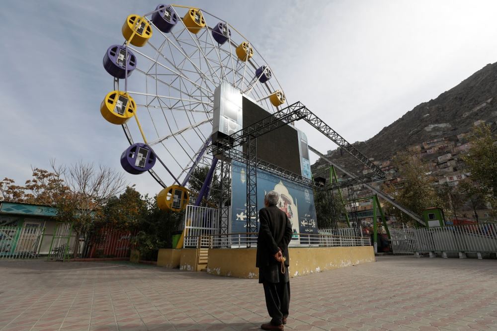 An Afghan man stands in an amusement park in Kabul, Afghanistan, on November 9, 2022. REUTERS/Ali Khara