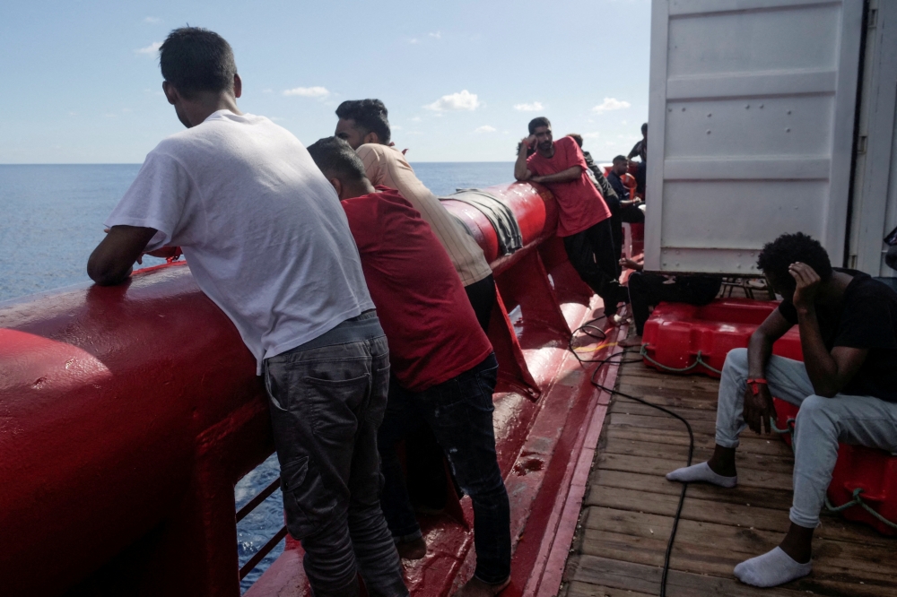 Migrants stand on deck of NGO rescue ship 'Ocean Viking', in the Mediterranean Sea, November 8, 2022. Camille Martin Juan/Sos Mediterranee/Handout via Reuters