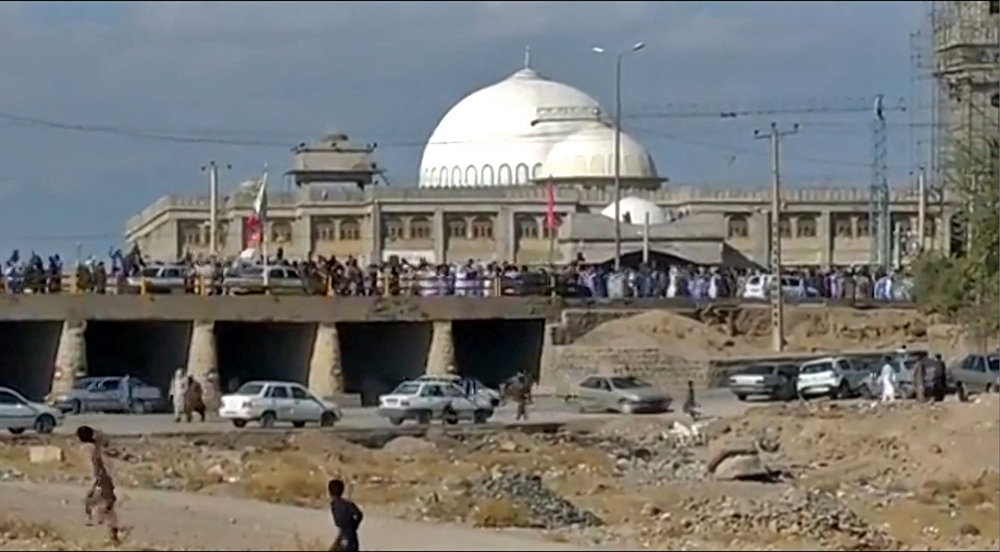 This image grab from a UGC video posted on November 11, 2022, shows protesters marching in Khash, in Iran's southeastern province of Sistan-Baluchistan. (Photo by UGC / AFP)