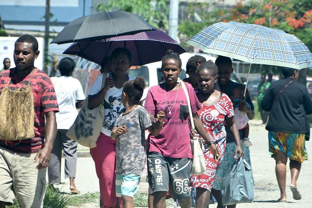 Families walk outside the hospital building in downtown of Honiara on November 22, 2022, as people rushed from their offices and fleeing to higher ground after a strong earthquake. Photo by Mavis PODOKOLO / AFP

