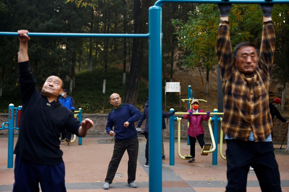 Elderly people exercise in the morning at a park in Beijing, China November 10, 2022. Reuters/Tingshu Wang