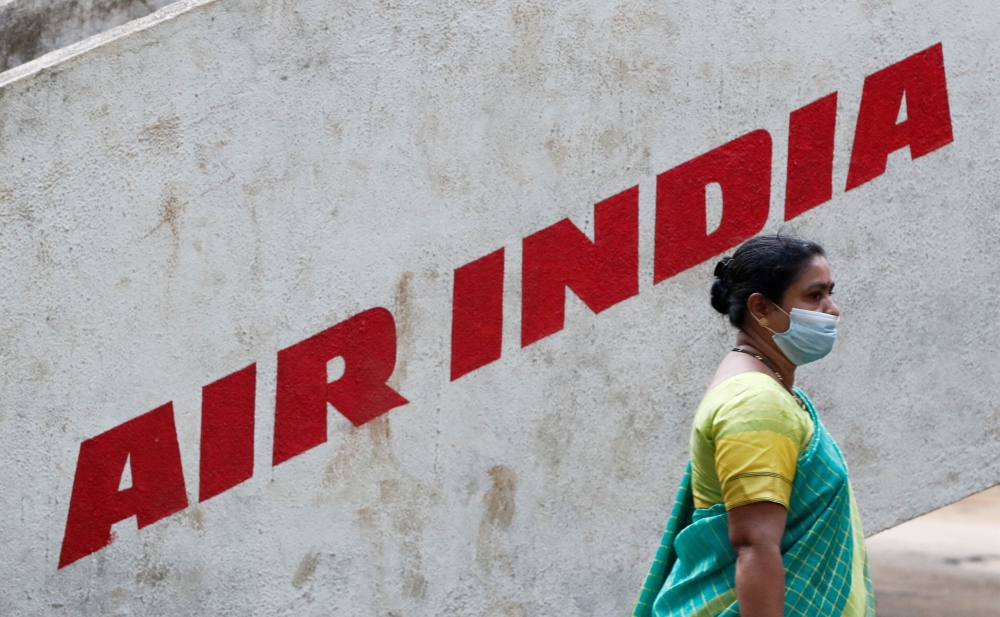 A woman walks past Air India airlines branding in Mumbai, India, October 19, 2021. (REUTERS/Francis Mascarenhas)