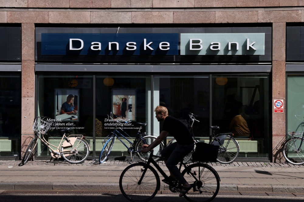 A person rides a bicycle past a Danske Bank branch in Copenhagen, Denmark, July 29, 2022. File Photo / Reuters
