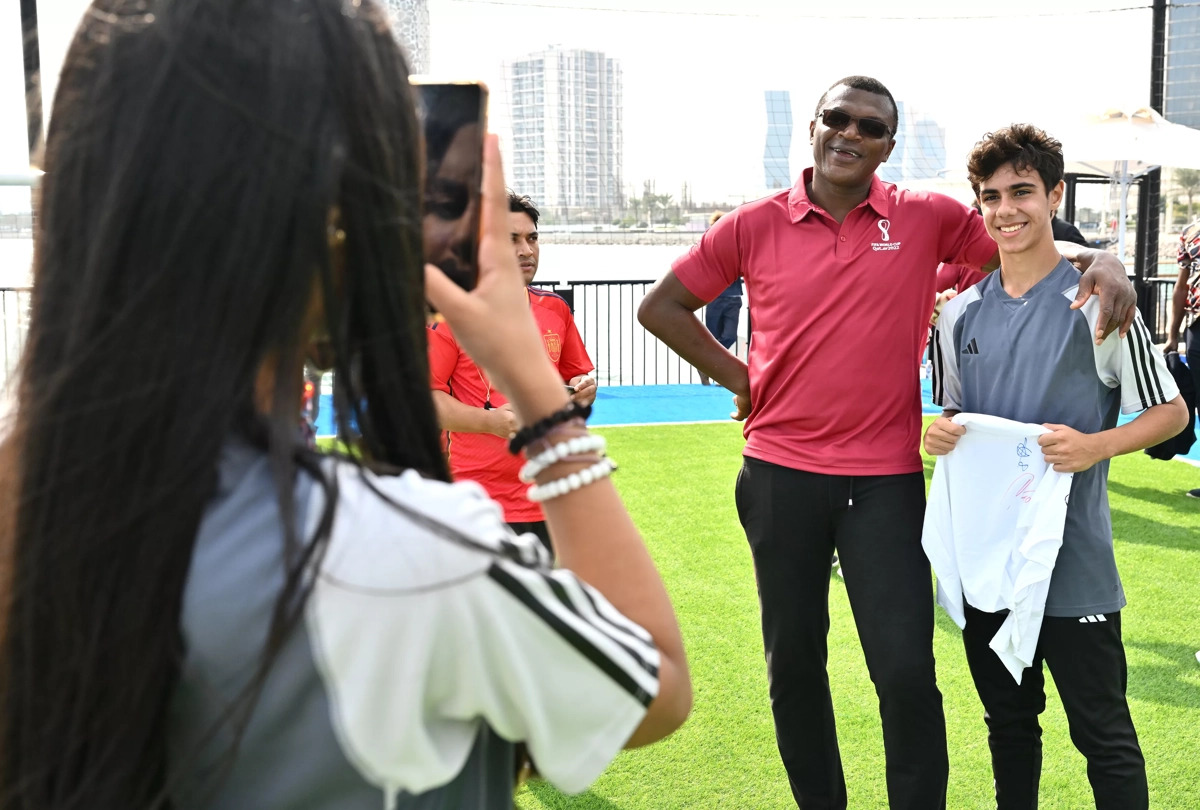 FIFA World Cup Ambassador Marcel Desailly poses with a Youth Programme participant.