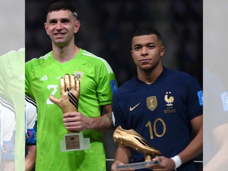 In this file photo taken on December 18, 2022, Argentina's goalkeeper Emiliano Martinez and France's forward Kylian Mbappe pose on the podium after receiving the Golden Glove and Golden Boot awards respectively, during the Qatar 2022 World Cup trophy ceremony after the football final match between Argentina and France at Lusail Stadium in Lusail, north of Doha. (Photo by Franck Fife / AFP)