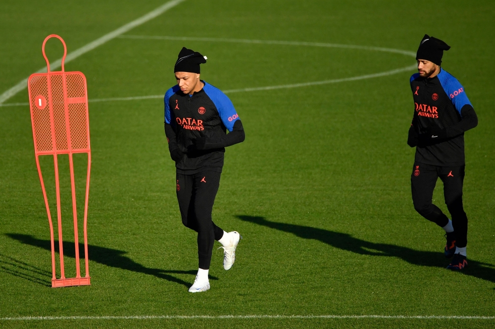 Paris Saint-Germain's Kylian Mbappe (left) and Neymar take part in a training session at the club's 