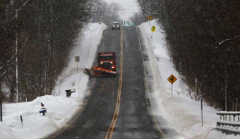 A snow plow travels down a stretch of open highway, working on the side roads following a deadly Christmas blizzard, in Elma, New York, US, December 27, 2022. (REUTERS/Robert Kirkham)