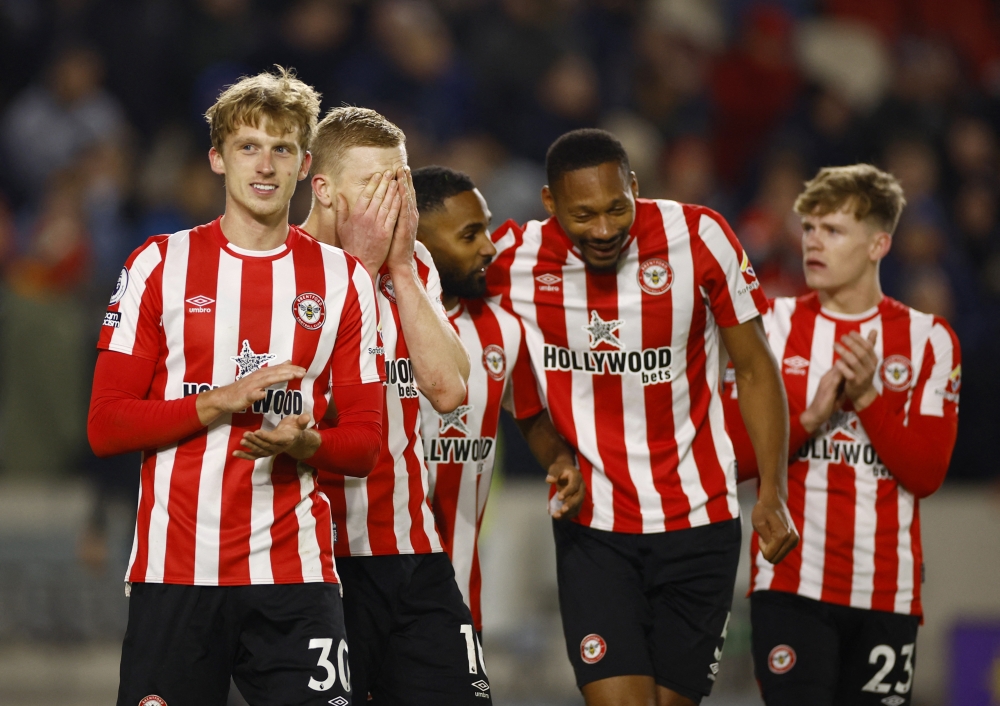 Brentford's Mads Roerslev, Ben Mee, Rico Henry and Ethan Pinnock celebrate after winning the Premier League match against Liverpool at Brentford Community Stadium, London, Britain, January 2, 2023. (Action Images via Reuters/John Sibley)