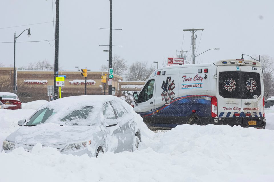 An ambulance passes an abandon car during a winter storm that hit the Buffalo region, in Amherst, New York, US, on December 26, 2022. REUTERS/Brendan McDermid