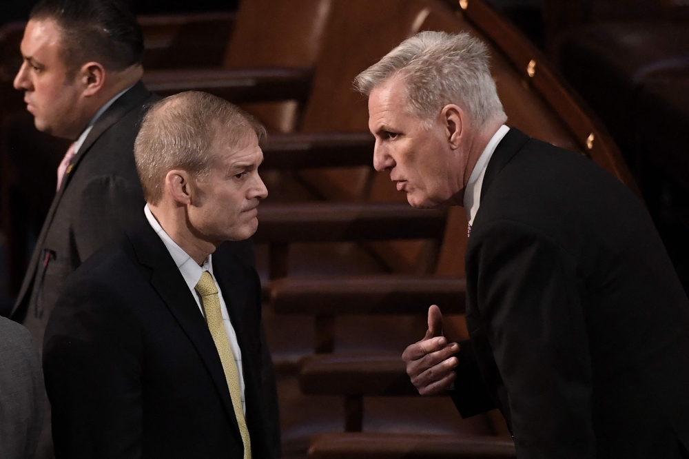 US Republican Representative from California Kevin McCarthy (right) speaks with Republican Representative from Ohio Jim Jordan as the US House of Representatives continues voting for new speaker at the US Capitol in Washington, DC, January 4, 2023.  (Photo by OLIVIER DOULIERY / AFP)
 