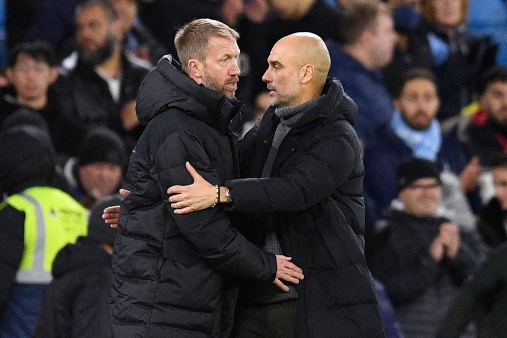 Chelsea's English head coach Graham Potter (left) and Manchester City's Spanish manager Pep Guardiola shake hands after the English FA Cup third round football match between Manchester City and Chelsea at the Etihad Stadium in Manchester, north-west England, on January 8, 2023. - Man City won the game 4-0 (Photo by Oli SCARFF / AFP)