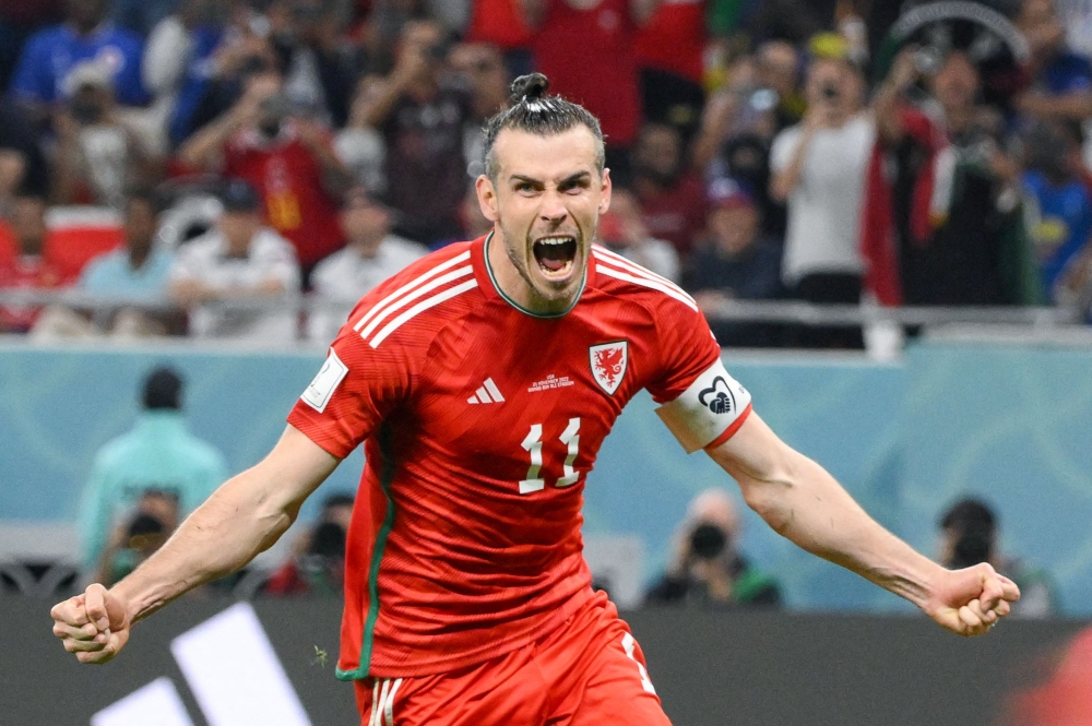 In this file photo taken on November 21, 2022 Wales' forward Gareth Bale celebrates scoring his team's first goal during the Qatar 2022 World Cup Group B football match between USA and Wales at the Ahmad Bin Ali Stadium in Al-Rayyan, west of Doha. (Photo by NICOLAS TUCAT / AFP)