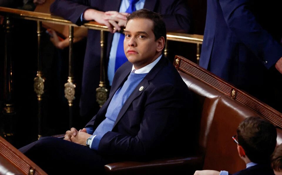 Newly elected freshman Rep. George Santos (R-NY), embroiled in a scandal over his resume and claims made on the campaign trail, sits alone in the House Chamber surrounded only by the children of other representatives, on the first day of the 118th Congress at the US Capitol in Washington, US, on January 3, 2023. REUTERS/Jonathan Ernst/File Photo
