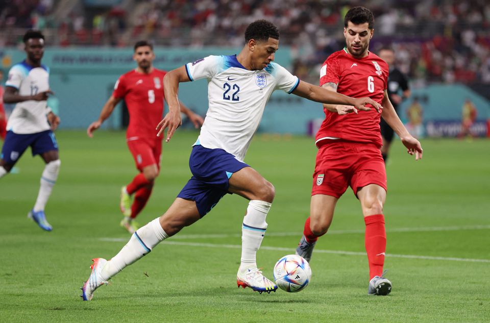 England's Jude Bellingham in action with Iran's Saeid Ezatolahi during the FIFA World Cup Qatar 2022 group match between England and Iran at Khalifa International Stadium on November 21, 2022. (REUTERS/Lee Smith)