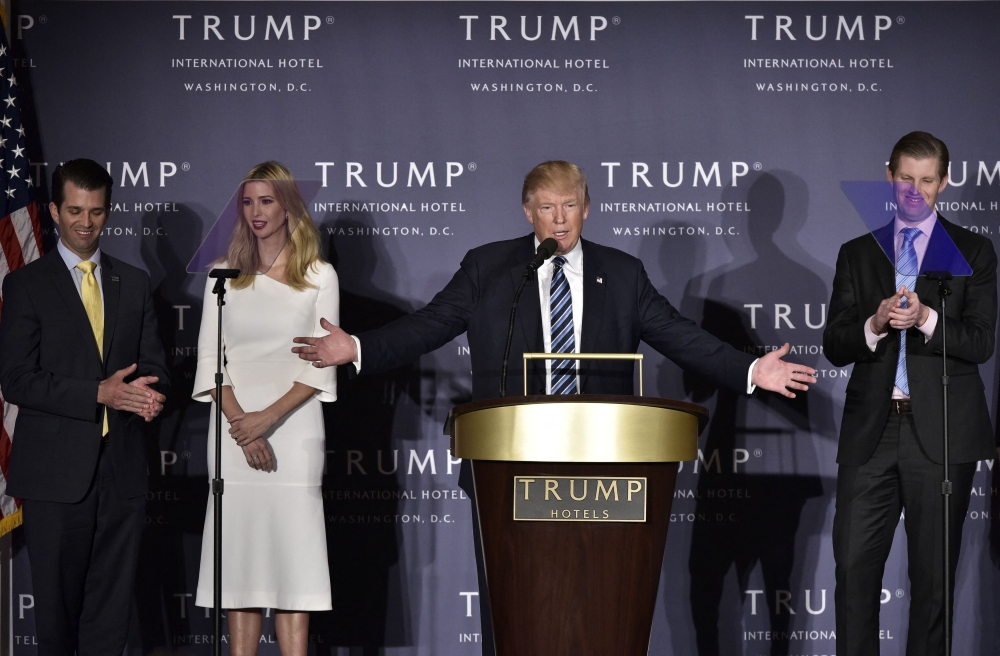 In this file photo taken on October 26, 2016, Republican presidential nominee Donald Trump, with children Donald Trump Jr., Ivanka Trump, and Eric Trump, during the grand opening of the Trump International Hotel in Washington, DC. (Photo by MANDEL NGAN / AFP)