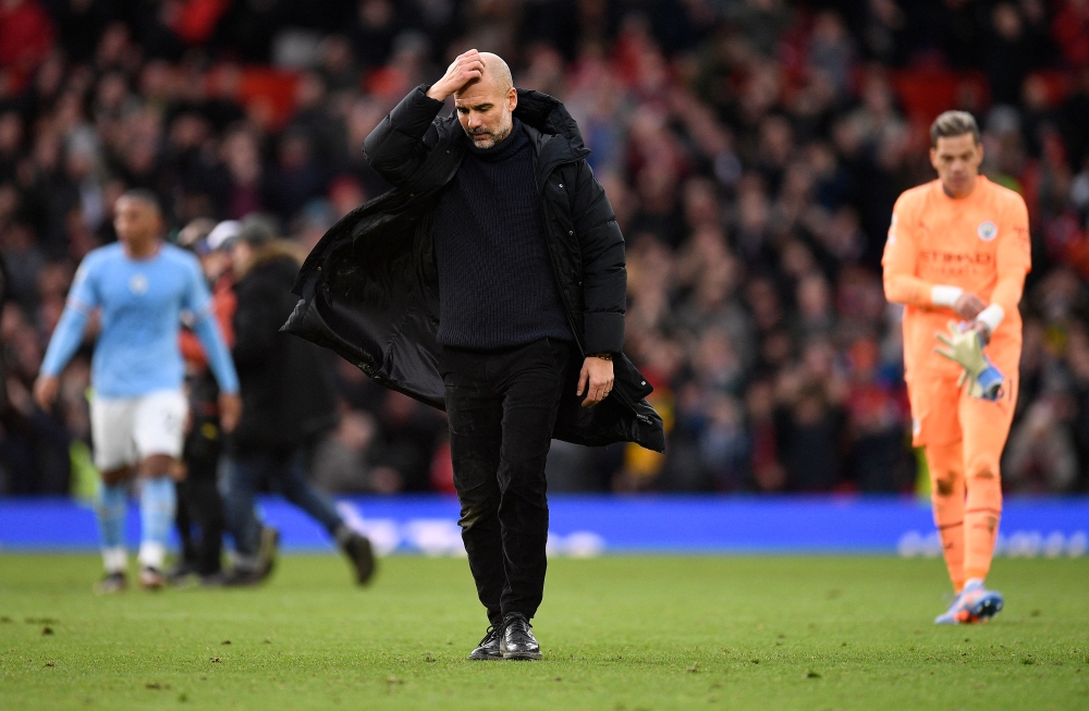 Manchester City's Spanish manager Pep Guardiola reacts after the English Premier League football match between Manchester United and Manchester City at Old Trafford in Manchester, north west England, on January 14, 2023. (Photo by Oli SCARFF / AFP)