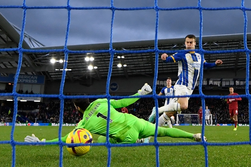 Brighton's English midfielder Solly March (centre right) score the opening goal past Liverpool's Brazilian goalkeeper Alisson Becker (L) during the English Premier League football match between Brighton and Hove Albion and Liverpool at the American Express Community Stadium in Brighton, southern England on January 14, 2023. - Brighton won the game 3-0. (Photo by Glyn KIRK / AFP) 