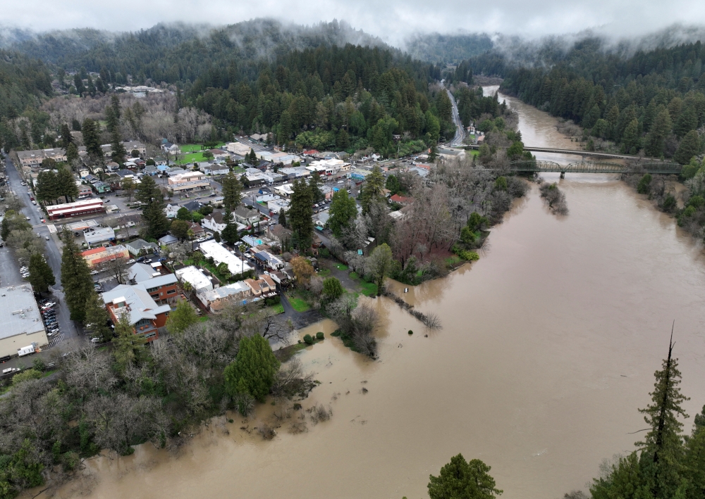 The Russian River, swollen with floodwater following a chain of winter storms, flows past the town of Guerneville, California, US on January 15, 2023. REUTERS/Fred Greaves
