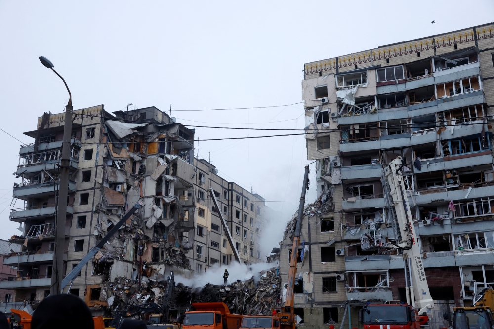 Emergency personnel work at the site where an apartment block was heavily damaged by a Russian missile strike, amid Russia's attack on Ukraine, in Dnipro, Ukraine January 15, 2023. REUTERS/Clodagh Kilcoyne