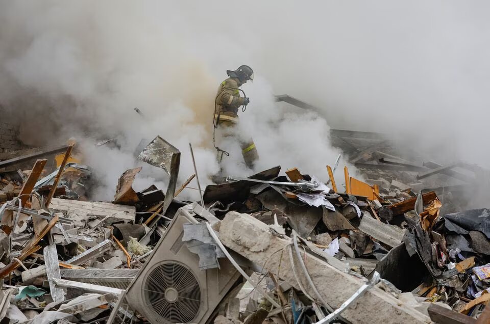 Emergency personnel work among debris at the site where a building was heavily damaged in recent shelling in the course of Russia-Ukraine conflict in Donetsk, Russian-controlled Ukraine, on January 16, 2023. REUTERS/Alexander Ermochenko
