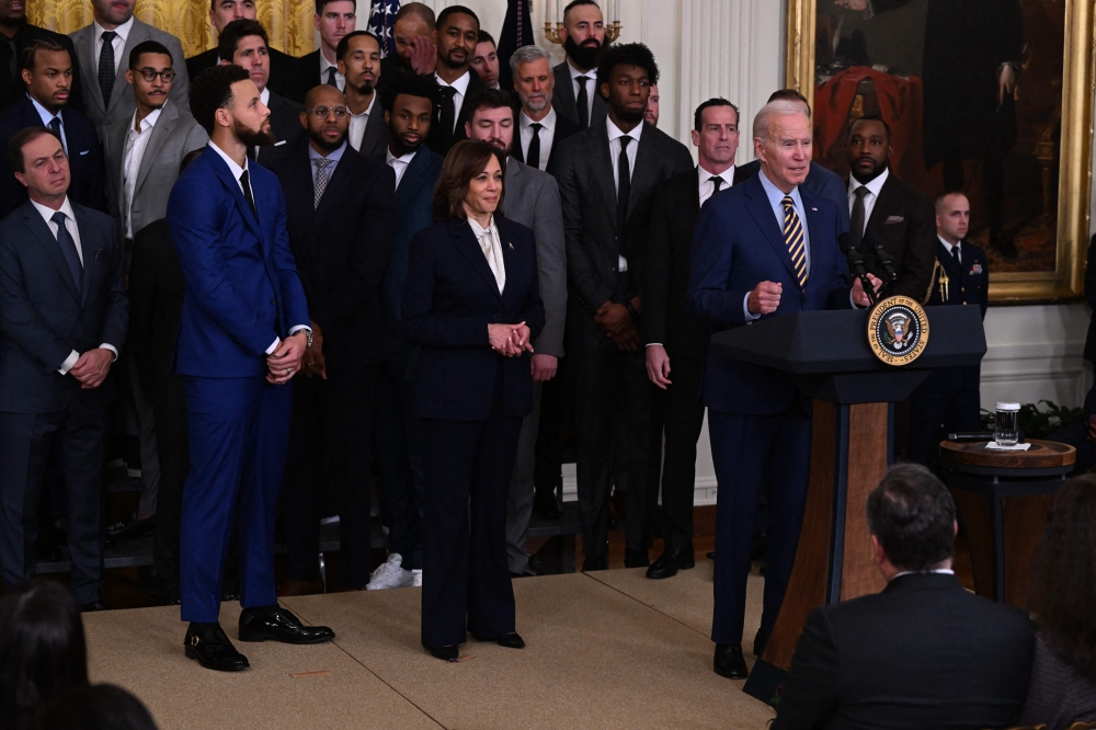 Golden State Warriors basketball player Stephen Curry, fellow members of the Golden State Warriors, and US Vice President Kamala Harris listen to US President Joe Biden speak during a celebration for the Golden State Warriors 2022 NBA championship, in the East Room of the White House in Washington, DC, on January 17, 2023. (Photo by Andrew CABALLERO-REYNOLDS / AFP)
 