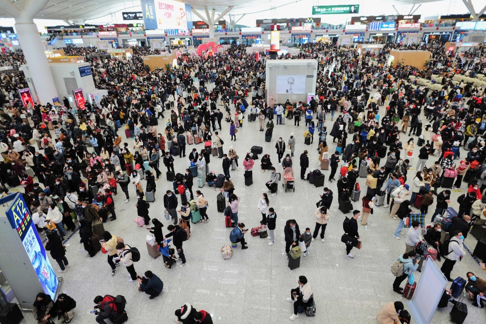 This photo taken on January 17, 2023 shows passengers arriving at Shenzhen North railway station during peak travel ahead of the Lunar New Year of the Rabbit, in China's southern Guangdong province. (Photo by CNS / AFP)