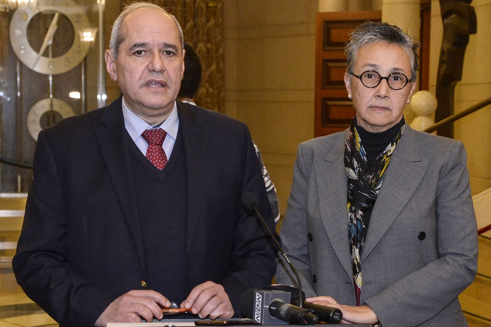 This handout picture provided by the Lebanese Parliament Press Office on January 19, 2023, shows Lebanese deputies Melhem Khalaf (left) and Najat Saliba giving a statement to the press at the end of a session in the parliament building, in the capital Beirut's downtown district. (Photo by Stringer / Lebanese Parliament / AFP)
