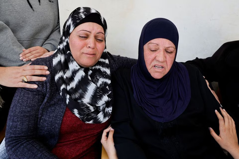 Family members of a Palestinian man, who was killed by Israeli forces after an attempted stabbing, react, near Ramallah, in the Israeli-occupied West Bank, January 21, 2023. REUTERS/Ammar Awad