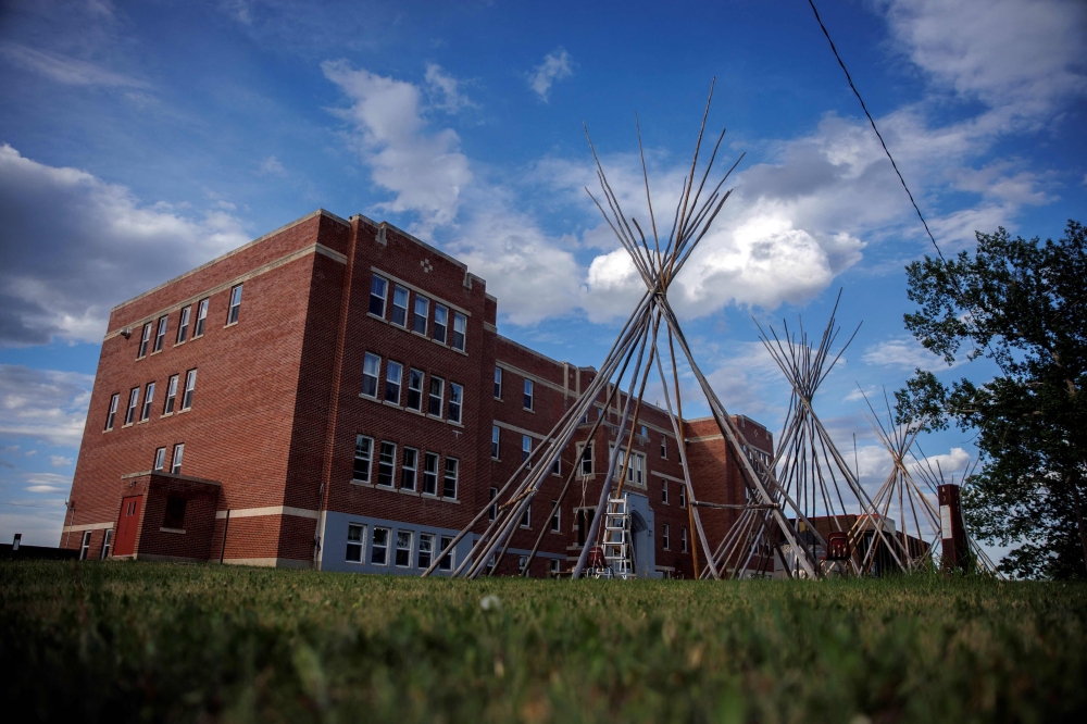 In this file photo taken on June 08, 2022, Teepee's stand outside the University nuhelt'ine tahiyots'i nistameyimakanak Blue Quills, the former residential school turned First Nation University, in St Paul, Alberta. (Photo by Cole Burston / AFP)