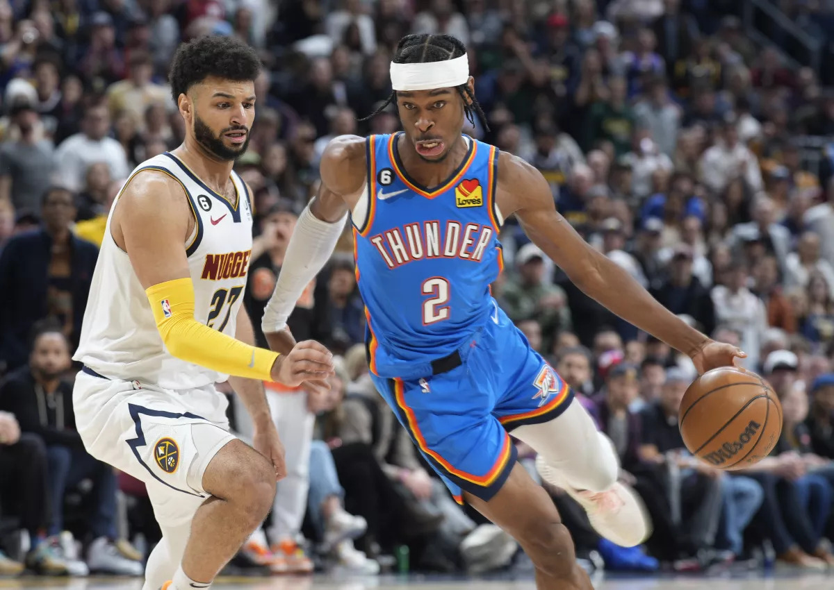 Oklahoma City Thunder guard Shai Gilgeous-Alexander, right, drives past Denver Nuggets guard Jamal Murray in the second half of an NBA basketball game Sunday, Jan. 22, 2023, in Denver. David Zalubowski / Associated Press
